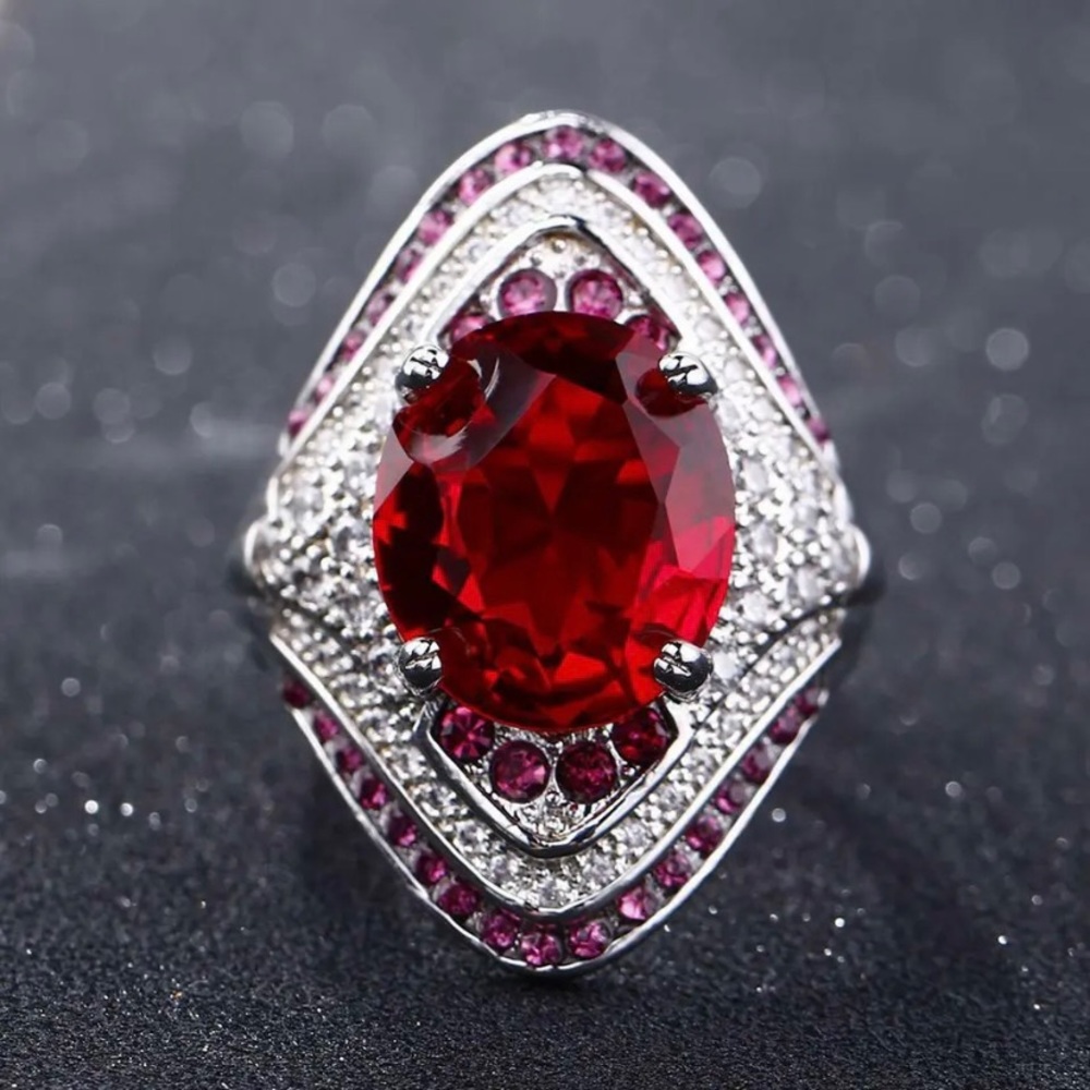 Red stone statement ring with pink accent stones in silver tone base